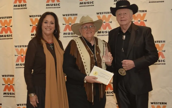Judy James receiving the 2013 DJ of the Year award at the Western Music Association, flanked by Anita La Cava Swift and Johnny Western