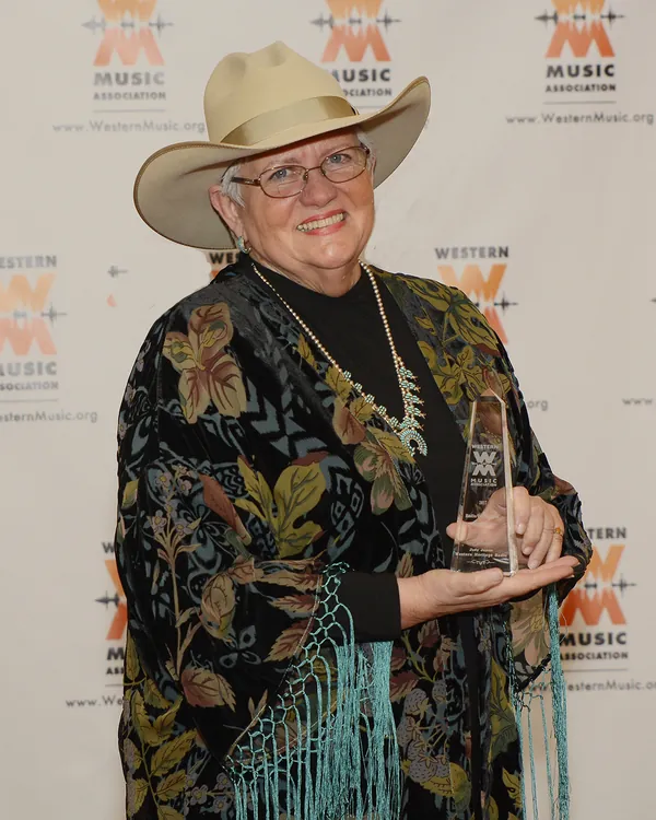 Judy James holding an award at the Western Music Association