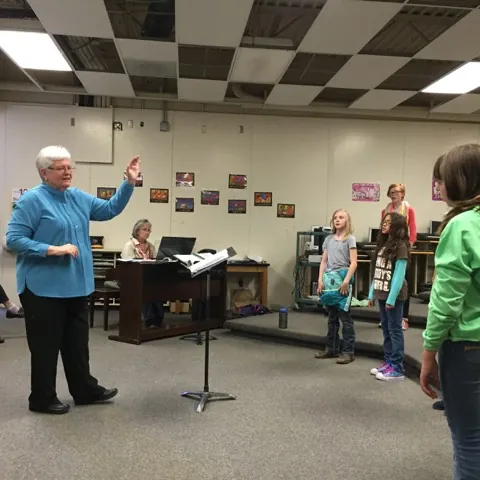 Judy James leading a youth choir rehearsal