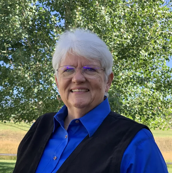 Portrait of Judy James outdoors in a blue shirt