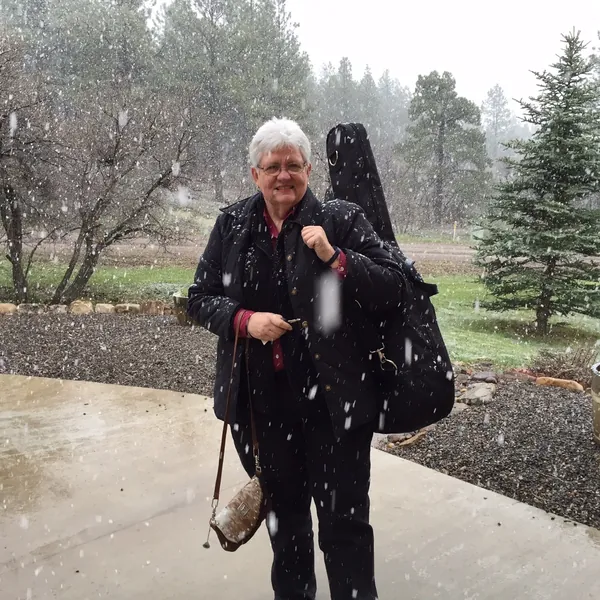 Heading to a gig in the snow, guitar on her shoulder